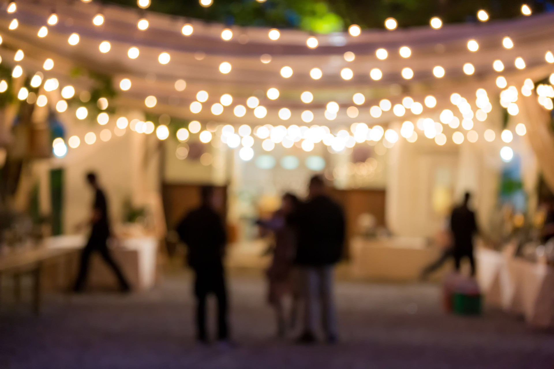vintage tone blur image of food stall at night festival with bokeh for background usage. Festival Event Party with People Blurred Background. Blur people having sunset beach party in summer vacation
